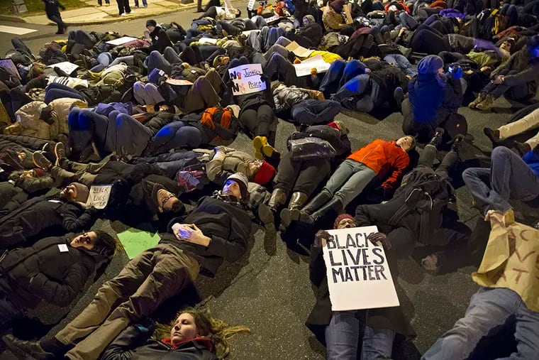 Hundreds protestors heeded the call of Philadelphia clergy of all faiths for a Solidarity Die-In at the intersection of S. Broad St. and Pattison Ave. after the Eagles Sunday night game December 7, 2014. CLEM MURRAY / Staff Photographer
