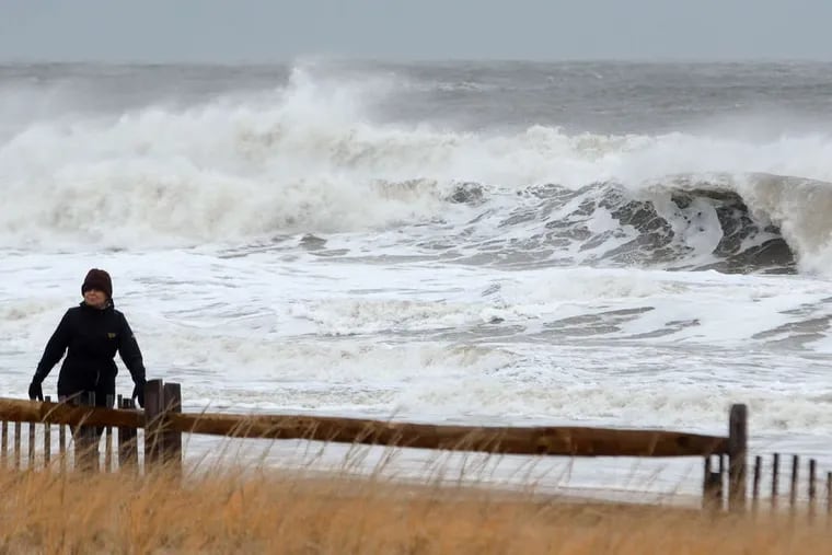 Agnes Love, 78, a retired teacher who winters in Ocean City walks the dunes as nor'easter generated waves pound the beach. Yesterday was "just wonderful," she said. "No precipitation, and the temperature is great. What more could you want?"