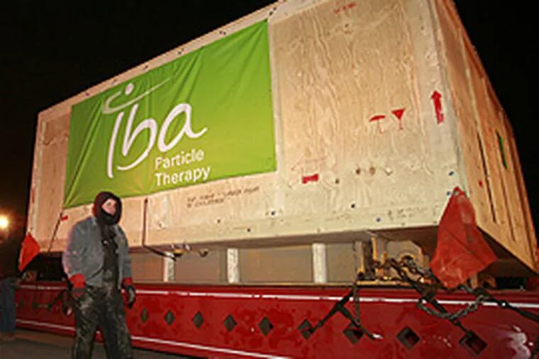 A 200-foot-long, 20-axle truck delivered a giant particle accelerator for Penn this morning for the world's largest proton therapy center. (Mike Levin/Inquirer)
