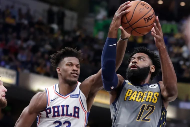 Indiana Pacers guard Tyreke Evans (12) shoots in front of Philadelphia 76ers guard Jimmy Butler (23) during the second half of an NBA basketball game in Indianapolis, Thursday, Jan. 17, 2019. The 76ers defeated the Pacers 120-96. (AP Photo/Michael Conroy)