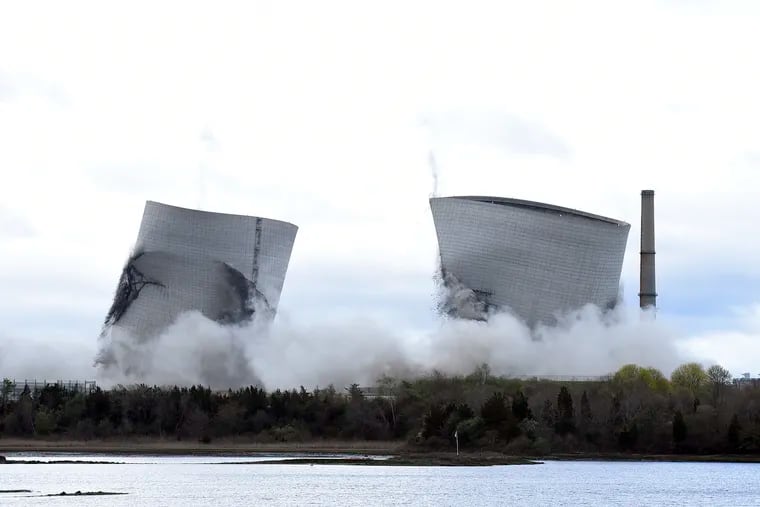 The two 500-foot cooling towers of the former Brayton Point Station collapse after explosive charges are detonated in Somerset, Mass., on April 27, 2019. The plant had burned coal since 1963. A trash burning plant in Martinsburg, West Va., aims to be part of the future.