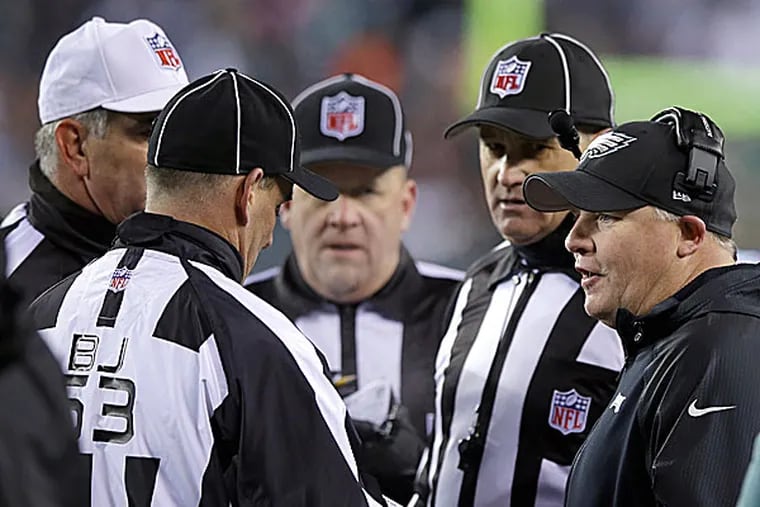 Eagles head coach Chip Kelly talk with NFL officials. (Michael Perez/AP)