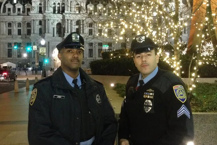 SEPTA cops who delivered baby: Sgt. Daniel Caban on the right. Officer Darrell James on the left. (Ben Finley / Staff)