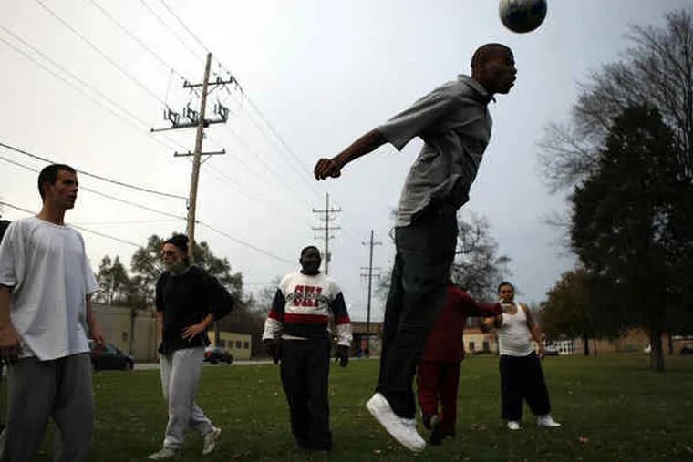 Team member Marcus Hicks heads a ball during practice. Only four players have soccer cleats.