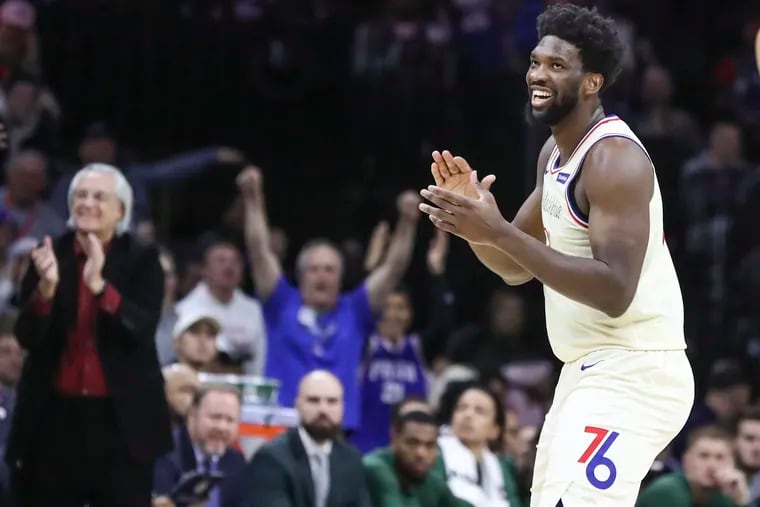 Joel Embiid celebrating after a Ben Simmons layup in December.