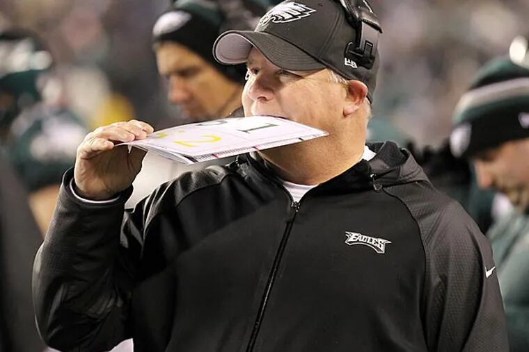 Eagles' Head Coach Chip Kelly bites his play card during the second
quarter agaist the New Orleans Saints on Saturday, January 4, 2014 in
the first round of the NFC playoffs.  ( Yong Kim / Staff Photographer
)