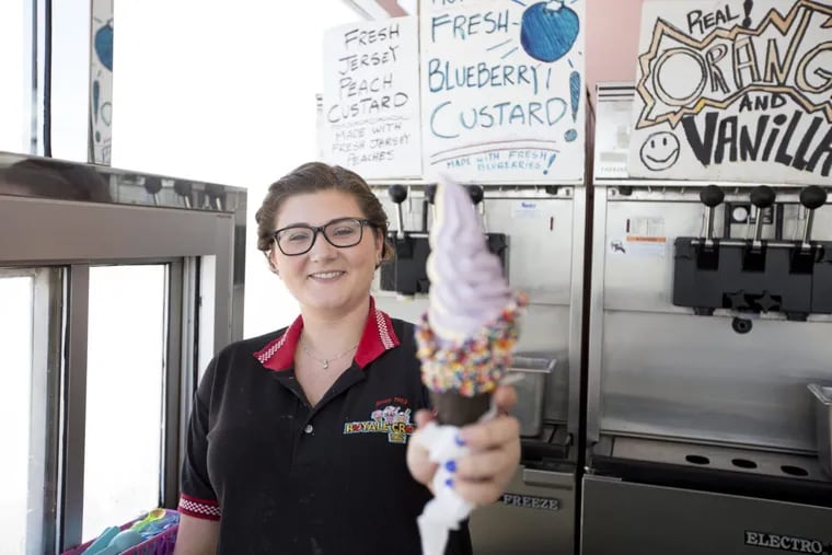 Nicole Inglesby holds a cone of blueberry and peach custard at Royale Crown in Hammonton on the White Horse Pike. (Margo Reed / Staff Photographer)