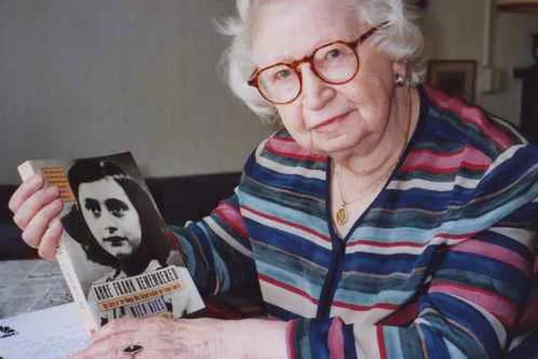 Miep Gies, at her Amsterdam apartment in 1998, displaying her book about Anne Frank. A new edition is coming out this year.