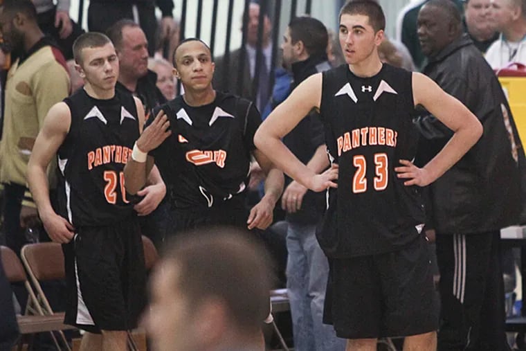 Pitman players  (left to right) Kyle Leach, Darnell Foreman and Tyler Wisniewski react to their 64-60 loss to  Linden.  (David M Warren/Staff Photographer)