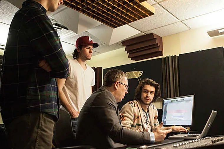 Toby Seay, a Drexel University music professor, with students (from left) Nick Myers, Brendan Monahan, and Ian Lavely. The students are finishing tapes from historic Sigma Sound Studios. (CHRIS FASCENELLI / Staff Photographer)