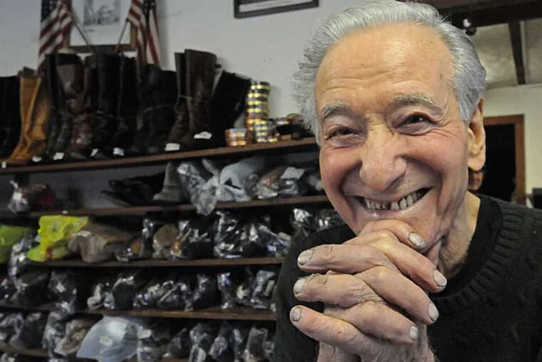 Shoe repairman James Spinelli takes a break, with some of his work at left. (April Saul/Staff)