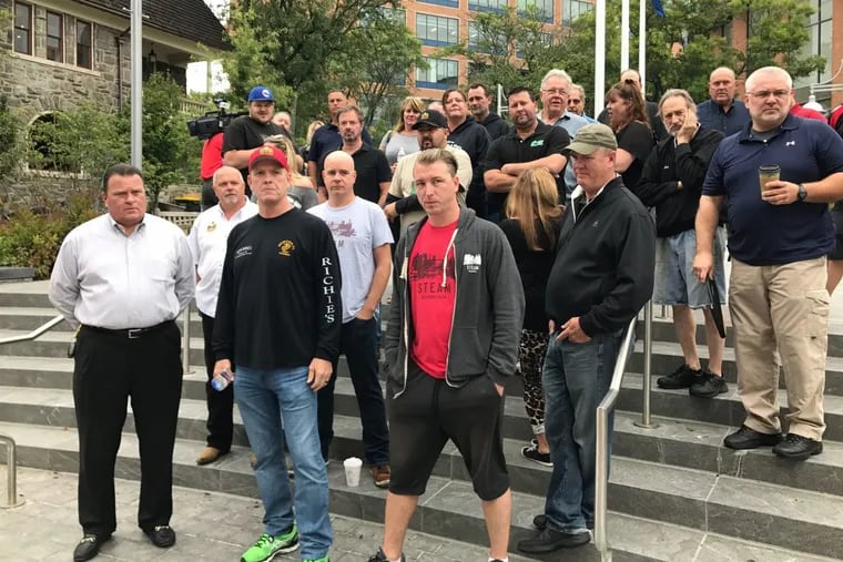 Tavern owners Tom Tyler, Jerry Walsh, and Martin Hoeger (front row, left to right) gather with other bar owners in front of the Bucks County Courthouse on Sept. 7 to rally in favor of video gaming terminals, which they say would help increase their profits.