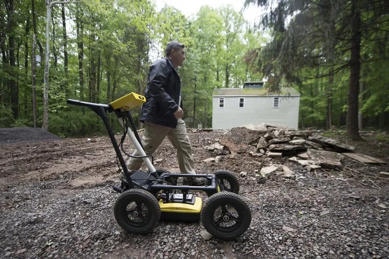 Bucks County Detective David Coyne walks near a ground-penetrating radar machine minutes before using it to search outside the ruins of the Fonder family’s home in Springfield Township. Edward Fonder III disappeared from the home in 1993 and hasn’t been heard from since.