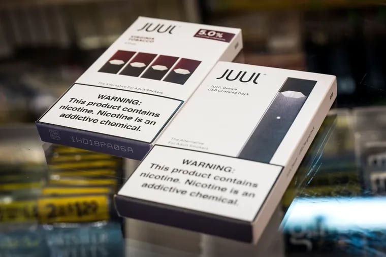 Packages of Juul Labs Inc. device kit and Virginia Tobacco pods are arranged for a photograph at a store in San Francisco.