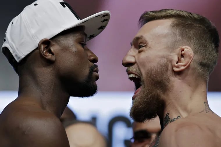 Floyd Mayweather Jr., left, and Conor McGregor face off during weigh-ins on Friday. The two are scheduled to fight Saturday in Vegas. (AP Photo/John Locher)