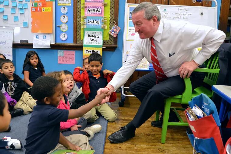 Mayor-elect Jim Kenney shakes hands with student Zachariah Bullock at Clara Barton School in Feltonville, where he, Superintendent William R. Hite Jr., and 30 others launched the $3.5 million campaign.