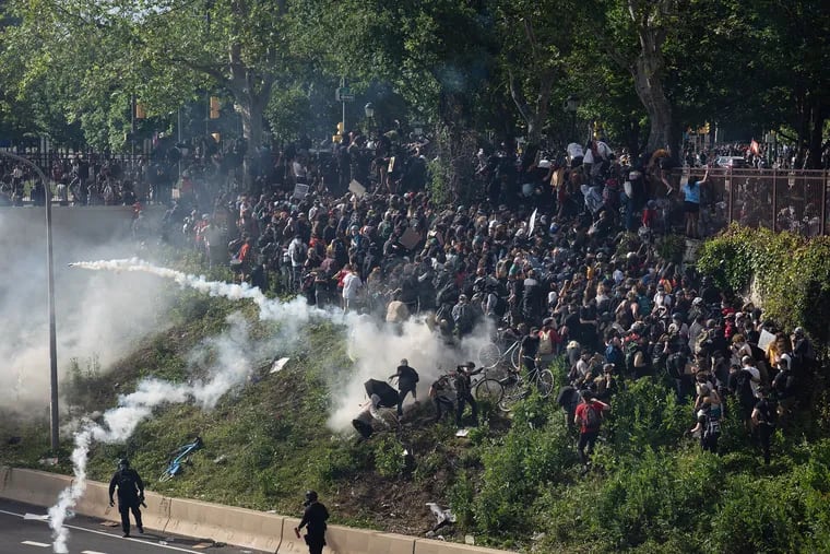 Officers fire tear gas at protestors who previously gathered on the Vine Street Expressway blocking traffic in Philadelphia, June 01, 2020, the third day of city protests following the killing of George Floyd in Minneapolis.