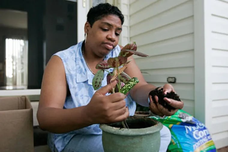 Adriane Livers, an administrative coordinator for a King of Prussia consulting firm, spends a weekday off repotting plants, doing housework or visiting family. (Michael Bryant / Inquirer)