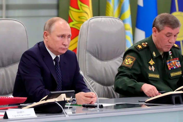 Russian President Vladimir Putin, left, and Chief of General Staff of Russia Valery Gerasimov oversee the test launch of the Avangard hypersonic glide vehicle from the Defense Ministry's control room in Moscow, Russia, Wednesday, Dec. 26, 2018. In the test, the Avangard was launched from the Dombarovskiy missile base in the southern Ural Mountains. The Kremlin says it successfully hit a designated practice target on the Kura shooting range on Kamchatka, 6,000 kilometers (3,700 miles) away. (Mikhail Klimentyev, Sputnik, Kremlin Pool Photo via AP)