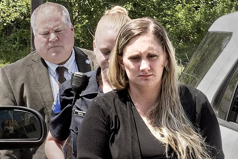 In a Friday July 13, 2018 photo, Samantha Jones, 30, is led into Magisterial Judge Jean Seaman's District Court in Warwick Township, Pa.,for her arraignment on homicide charges of killing her 11-month-old son through her drug-laced breast milk. (Kim Weimer/Bucks County Courier Times via AP)