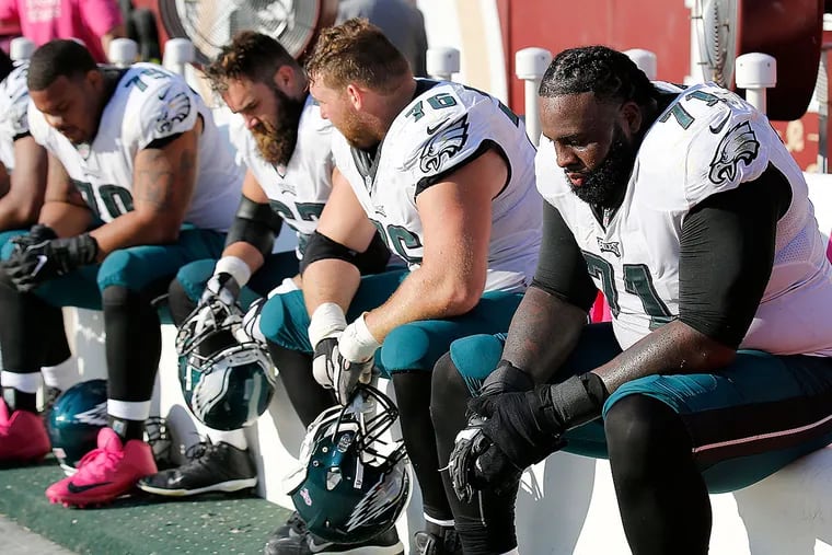Eagles offensive lineman Jason Peters, Allen Barbre, Jason Kelce and and Brandon Brooks sit on the bench.