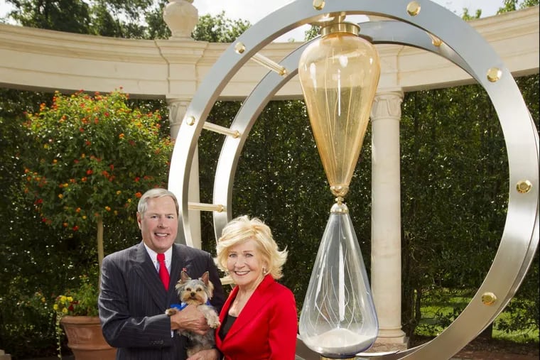 Vernon and Shirley Hill, posing with a Murano day glass time piece.