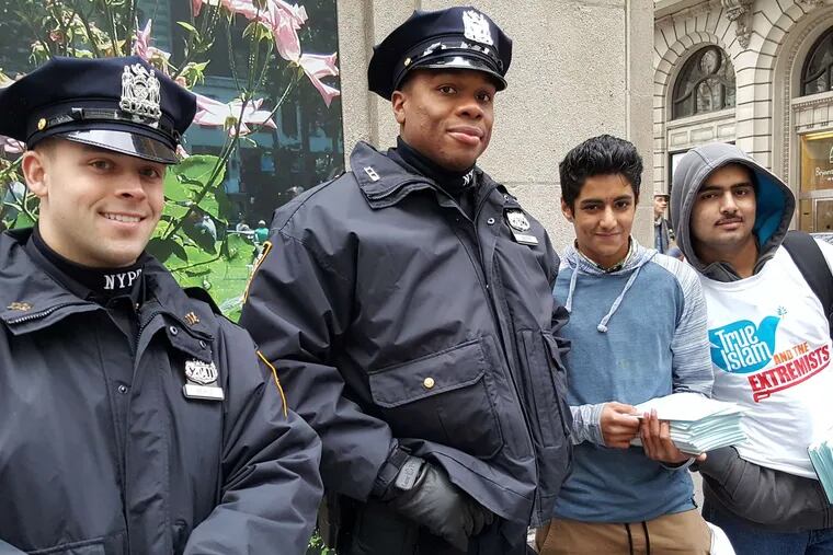 New York City cops, with members of the Ahmadiyya Muslim sect, who are distributing literature opposing Islamic extremism.