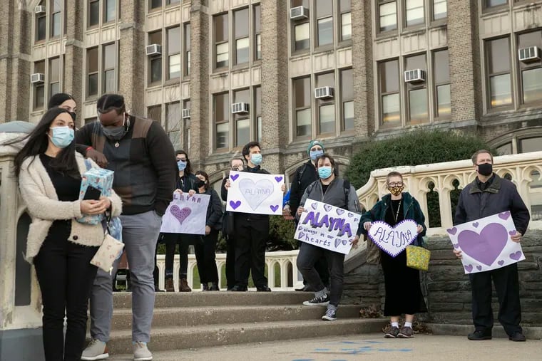 Teachers, students and staff at Olney Charter High School pause for a moment of silence for senior Alayna Thach, who died of COVID-19 this week, on Friday. Thach was remembered with speeches before a walk of light around the school and a moment of silence.