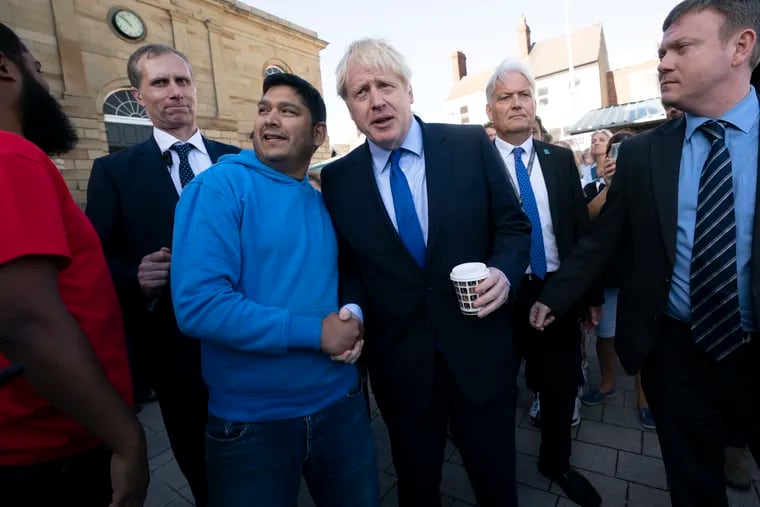 Britain's Prime Minister Boris Johnson shakes hands with a member of the public during a visit to Doncaster Market, in Doncaster, Northern England, Friday Sept. 13, 2019. Johnson will meet with European Commission president Jean-Claude Juncker for Brexit talks Monday in Luxembourg.