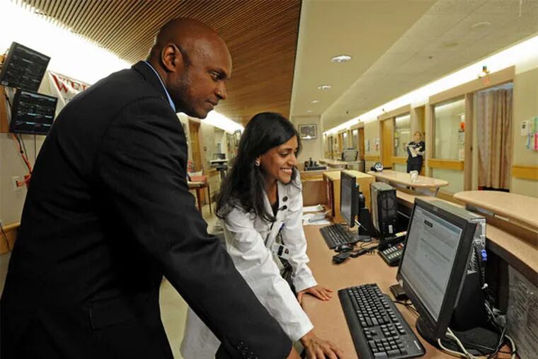 At Penn Medicine, Michael Anderson, associate director of clinical management, and Dr. Meera Gupta look at a computer screen with the Yorn system on it. (April Saul / Staff Photographer)