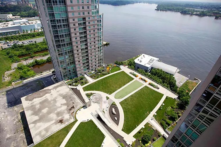 A view of the Delaware River from a 19th-floor patio of Waterfront Square's 22-story Reef Tower. &quot;We're selling four [units] a month,&quot; says David Grasso, who took control of the troubled project in late 2011. (David Swanson/Staff)
