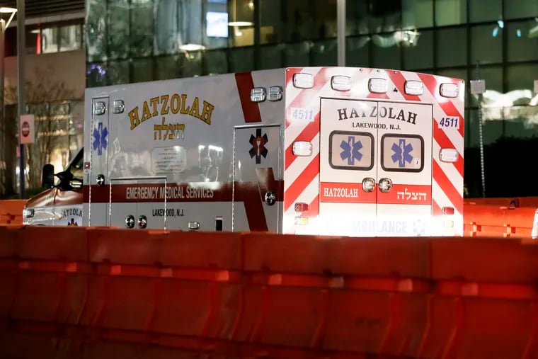 An ambulance with HATZOLAH LAKEWOOD, NJ identification on the vehicle pulls away from the Univ. of Penn hospital emergency entrance just after 8 pm,  on March 31, 2020. The death toll from the coronavirus epidemic  (COVID-19) is estimated to take between 100,000-240,000 US lives.