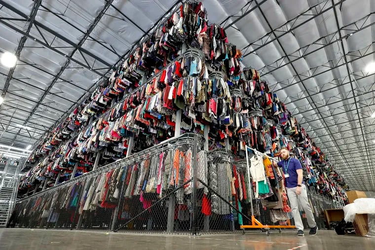 FILE - Thousands of garments are stored on a three-tiered conveyor system at the ThredUp sorting facility in Phoenix on March 12, 2019. A wardrobe purge is on for some as vaccinations have taken hold, restrictions have lifted and offices reopen or finalize plans to do so. The primary beneficiaries are secondhand clothing marketplaces, and brick-and-mortar donation spots. (AP Photo/Matt York, File)