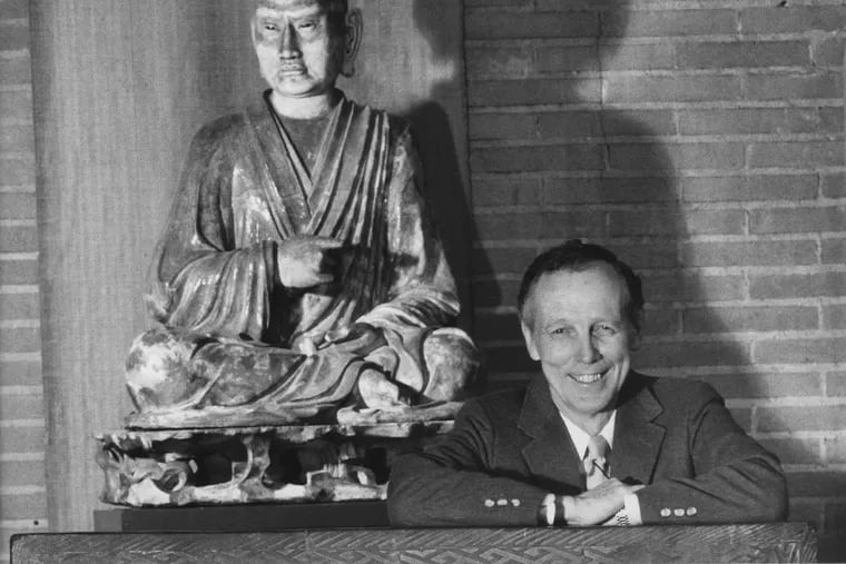 Robert H. Dyson next to the seated luohan in the museum's Asia Galleries in 1988.