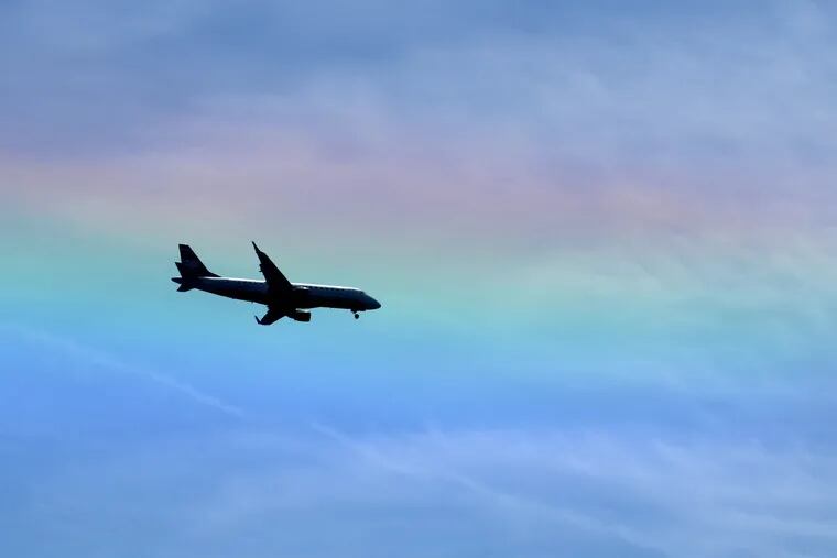 May 14, 2013: A jetliner landing at Philadelphia International airport flies through a sun dog. While some are bright and colorful, a sun dog is not a type of rainbow. They are both created by refraction, but rainbows are seen when raindrops create a prism effect, the color in sun dogs comes from dispersion in atmospheric ice crystals. TOM GRALISH / Staff Photographer