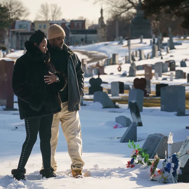 (Left to Right) Cindy and Bryant Heard, at the grave of their son Bryant Heard II, at Northwood Cemetary, in Philadelphia, Monday, January 31, 2022. Their son was fatally shot near their home in Olney last year.