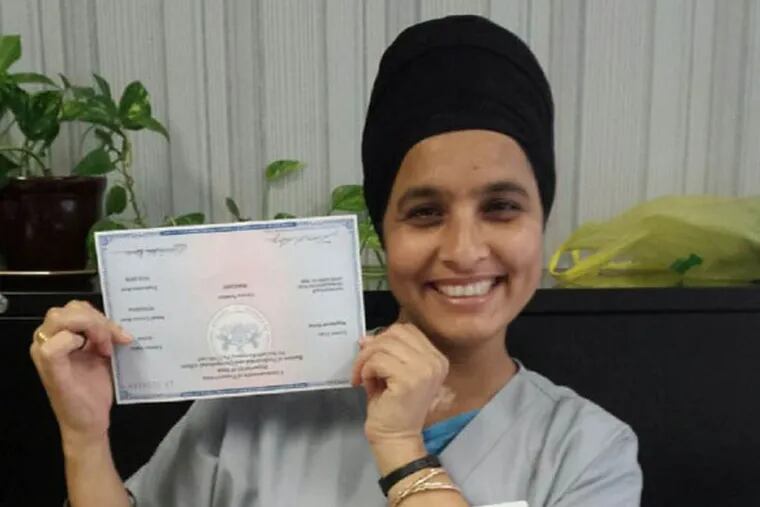 Harvinder Kaur, who came to the U.S. from India, shows her Pennsylvania registered-nurse license that she received this year. She works as an RN at the Little Sisters of the Poor’s Holy Family Home nursing home in Kingsessing. She began there as a certified nursing assistant and got that job through the the Welcoming Center for New Pennsylvanians.
Credit: Submitted photo