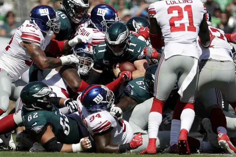 Eagles’ Carson Wentz  rushes for a first down during the first half against the Giants.