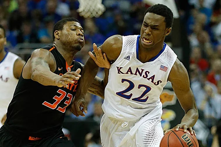 Kansas guard Andrew Wiggins is covered by Oklahoma State guard Marcus Smart. (Orlin Wagner/AP)