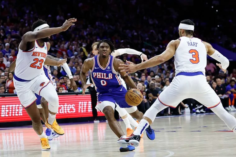 Sixers guard Tyrese Maxey dibbles the basketball against New York Knicks center Mitchell Robinson (left) and guard Josh Hart during Game 6.