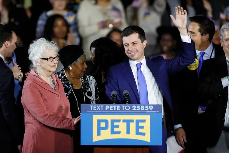 Democratic presidential candidate former South Bend, Ind., Mayor Pete Buttigieg and his mom Anne Montgomery, left, greet supporters at a caucus night campaign rally, Monday in Des Moines, Iowa.
