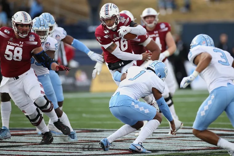 Temple quarterback Todd Centeio (16) carries the ball past North Carolina defensive back Myles Dorn (1) during the Owls' 55-13 Military Bowl loss on Friday. Centeio could challenge for more playing time next season.