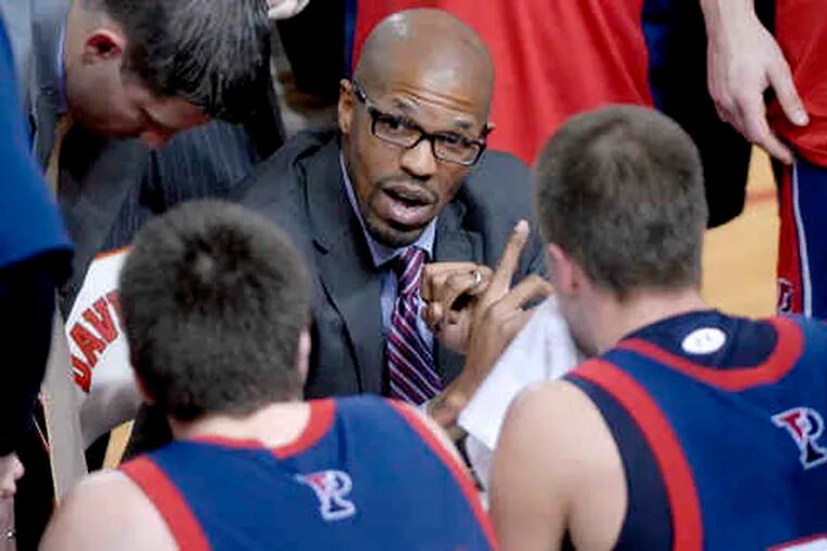Interim Penn coach Jerome Allen talks to his team during a time-out at John M. Belk Arena in Davidson, N.C. Allen replaced the fired Glen Miller earlier this month.