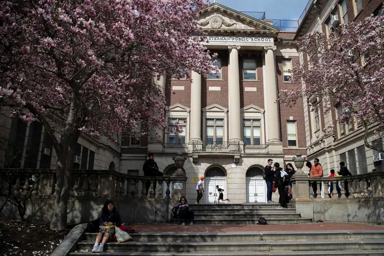 Students play in the courtyard outside of Masterman Public School in Philadelphia on Friday, March 13, 2020. The Pennsylvania Department of Education announced that school will be allowed to reopen July 1, though they must submit health and safety plans to the state.