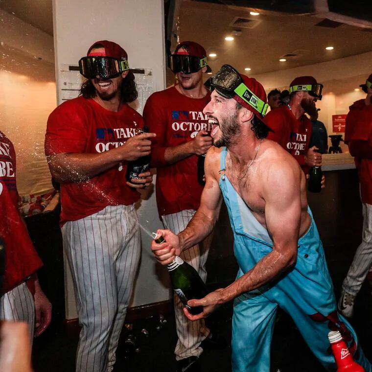 Phillies catcher Garrett Stubbs sprays champagne on teammates after the Phillies clinched a postseason berth for the second time in as many seasons.