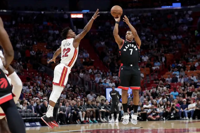 Toronto Raptors guard Kyle Lowry attempts a three-pointer as Miami Heat forward Jimmy Butler defends during an NBA basketball game, Thursday, Jan. 2, 2020, in Miami.