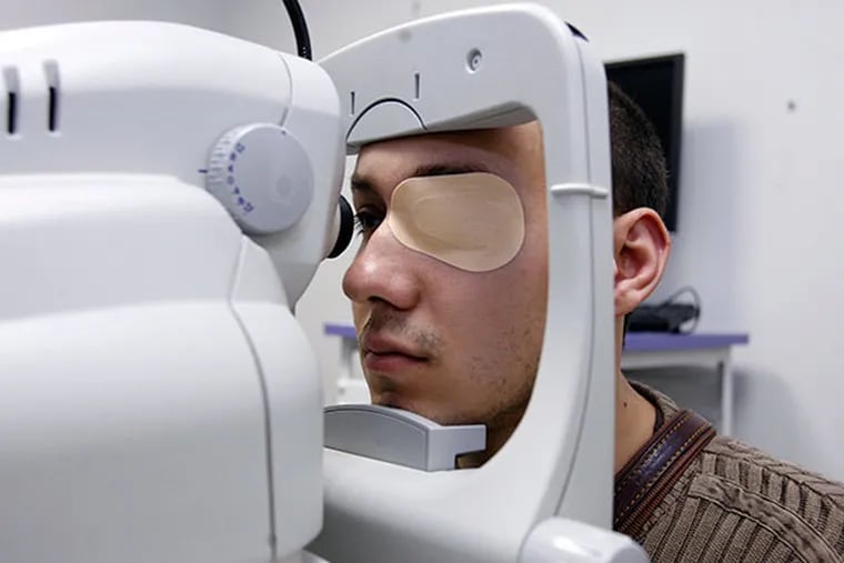 Tommaso Ferraro has his eyes examined during a checkup.  Tommaso is going through experimental gene therapy to overcome his blindness. 
Tommaso's blind sister, Josalinda Ferraro (not pictured), is also going through the treatment.  (FILE - Charles Fox / Inquirer)