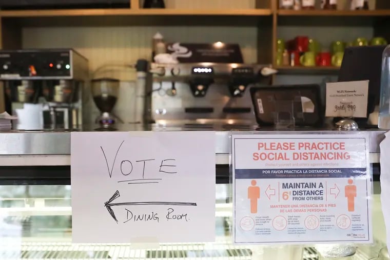 A Vote sign hangs on the counter at the Gold Standard Cafe in West Philadelphia on Tuesday, Nov. 02, 2021.