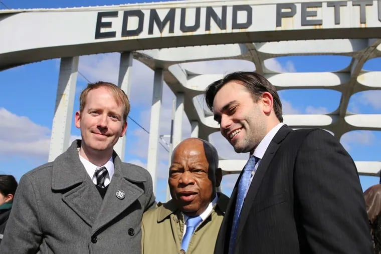 U.S. Rep. John Lewis (center) with the co-creaters of &quot;March,&quot; illustrator Nate Powell (left) and co-author Andrew Aydin on the Edmund Pettus Bridge.