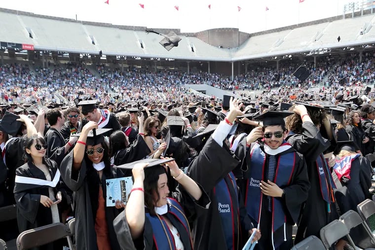 Some graduates toss their caps as members of the Class of 2020 and master’s and doctoral graduates of the Class of 2021 returned to Penn for a special in-person commencement ceremony at Franklin Field in Philadelphia on Sunday.